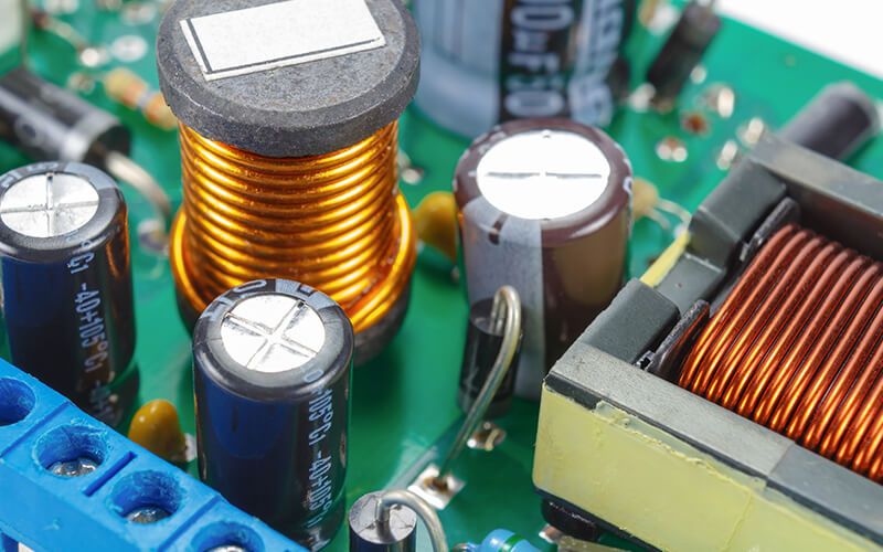 Capacitors, inductors, and other electronic components on a green motherboard